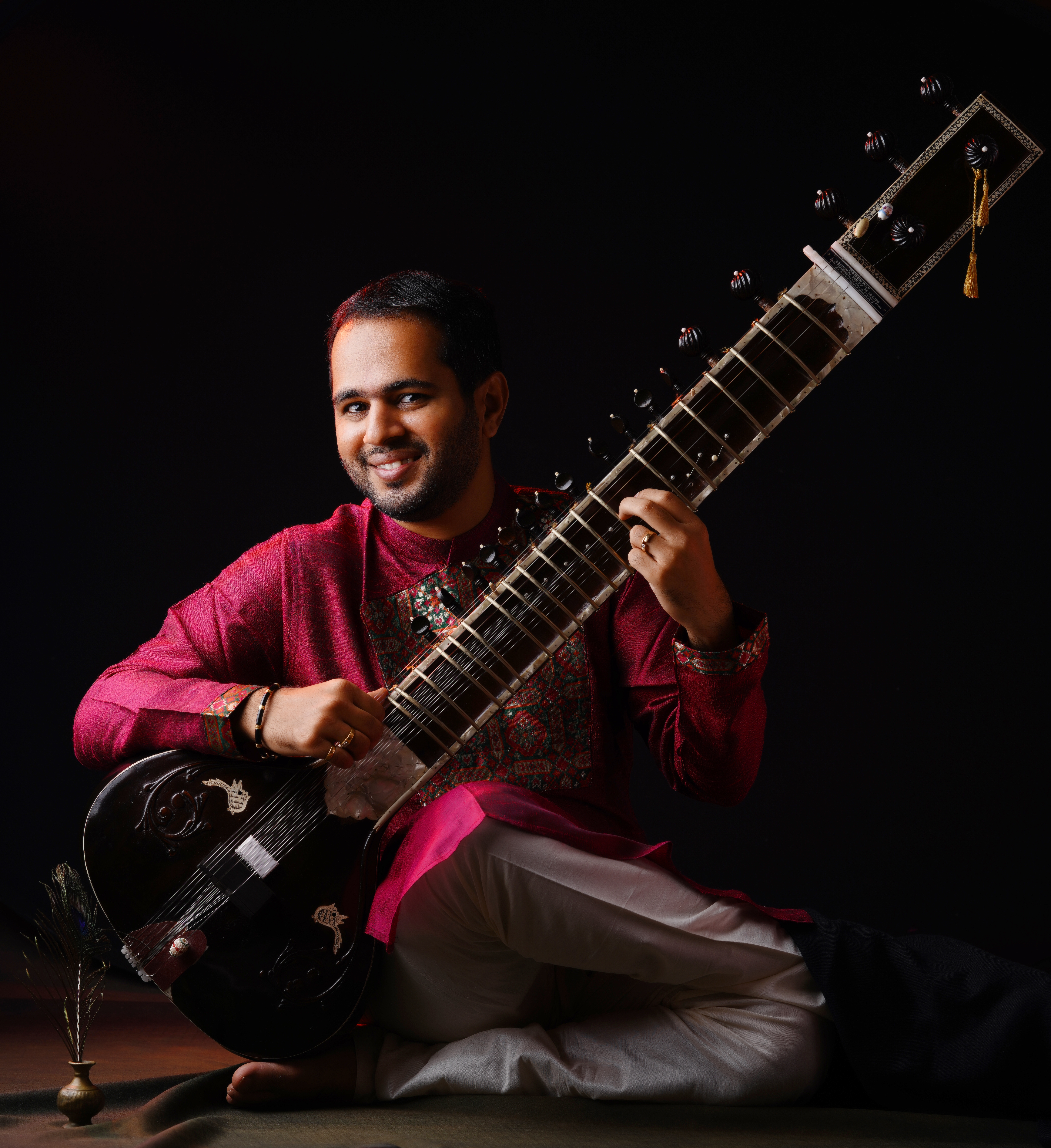 Ankush N Nayak smiling with sitar in black attire