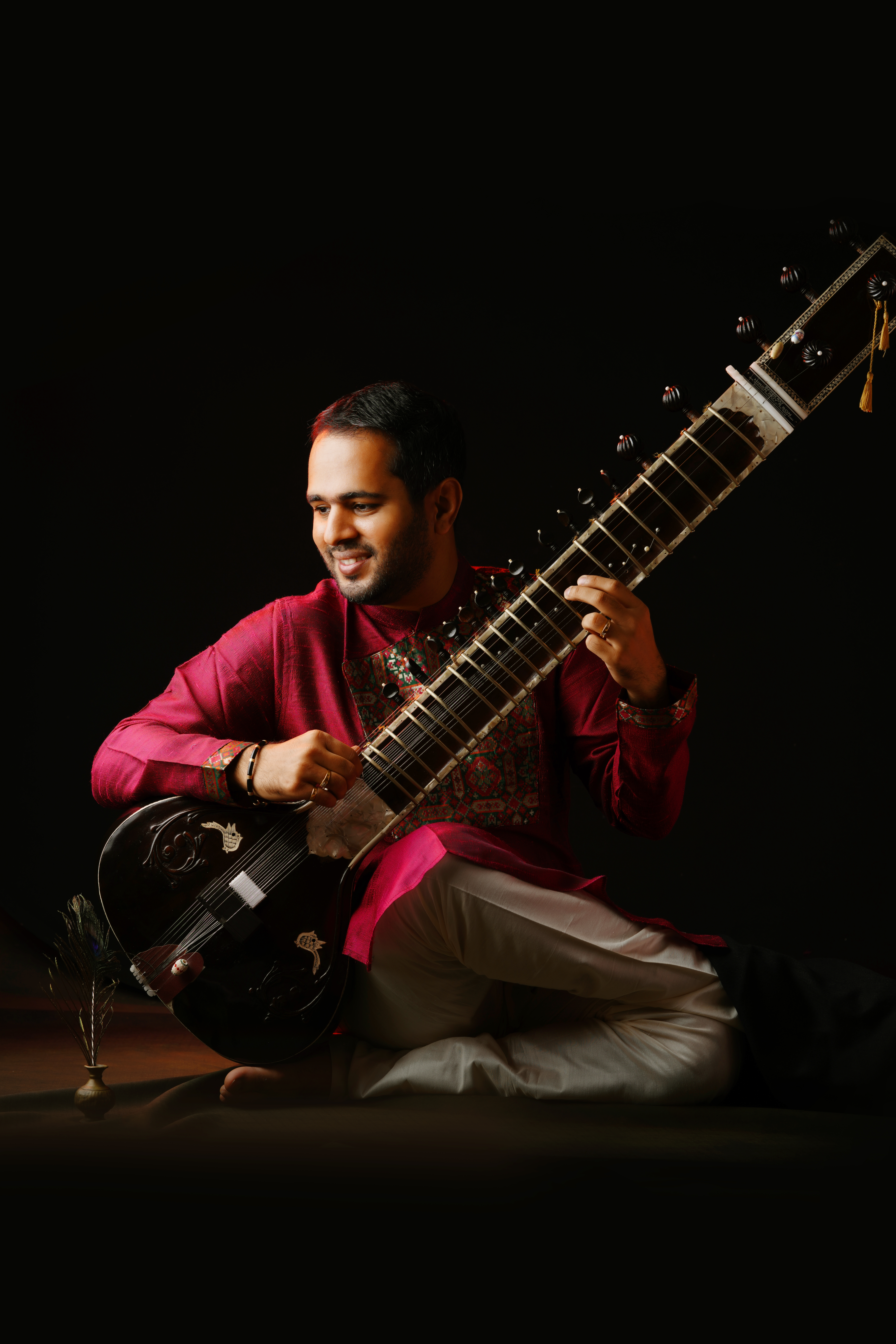 Vertical portrait of Ankush N Nayak in maroon attire